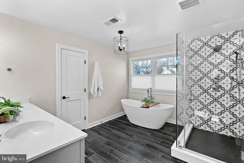 a bedroom with a bed and a ceiling fan