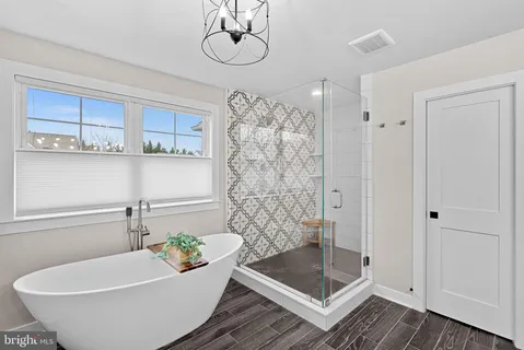 a bathroom with a shower a sink and a toilet