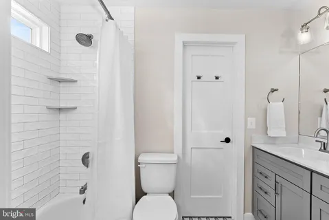 a bathroom with a double vanity sink a mirror and shower