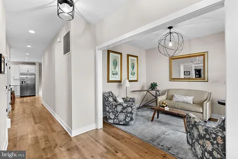 a living room with furniture a window and wooden floor