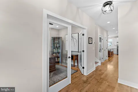a view of a hallway with a dining area a sink and refrigerator