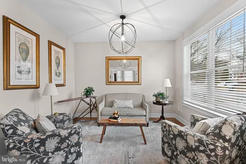 a living room with furniture chandelier and window