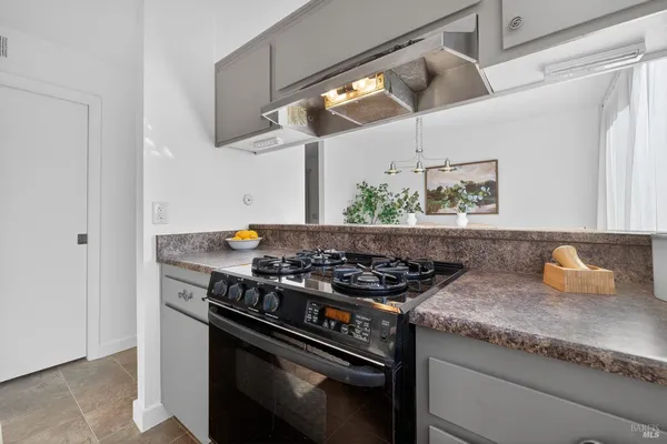 a kitchen with stainless steel appliances granite countertop a stove and a sink