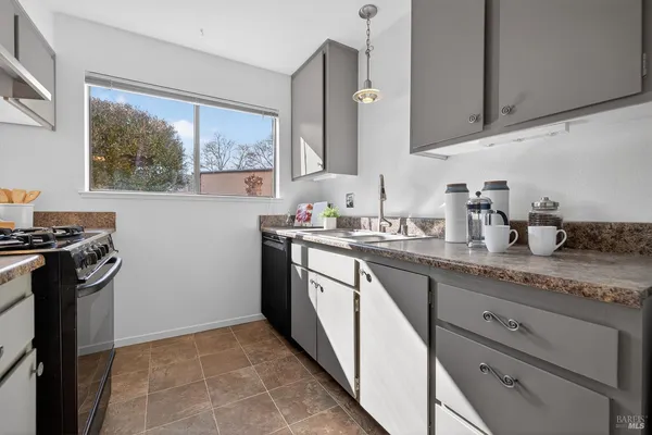 a kitchen with stainless steel appliances granite countertop a stove and a sink