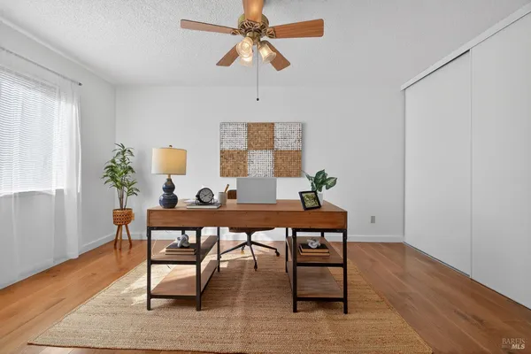 a workspace with wooden floor and a window