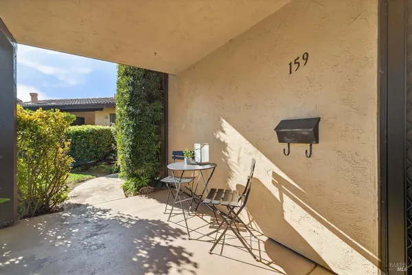 a potted plant sitting on a table in front of a building