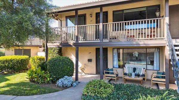 an aerial view of a house with swimming pool and outdoor seating