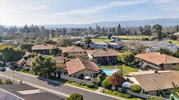 an aerial view of residential houses with outdoor space