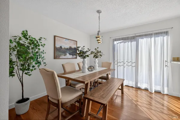 a view of a dining room with furniture and window