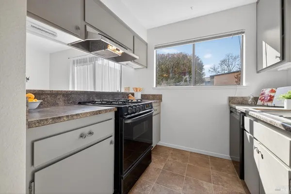a kitchen with stainless steel appliances granite countertop a stove and a sink