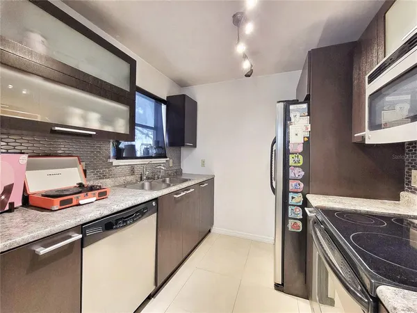 a kitchen with stainless steel appliances granite countertop a sink and a stove