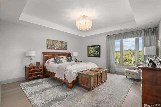 a bedroom with bed and a large window