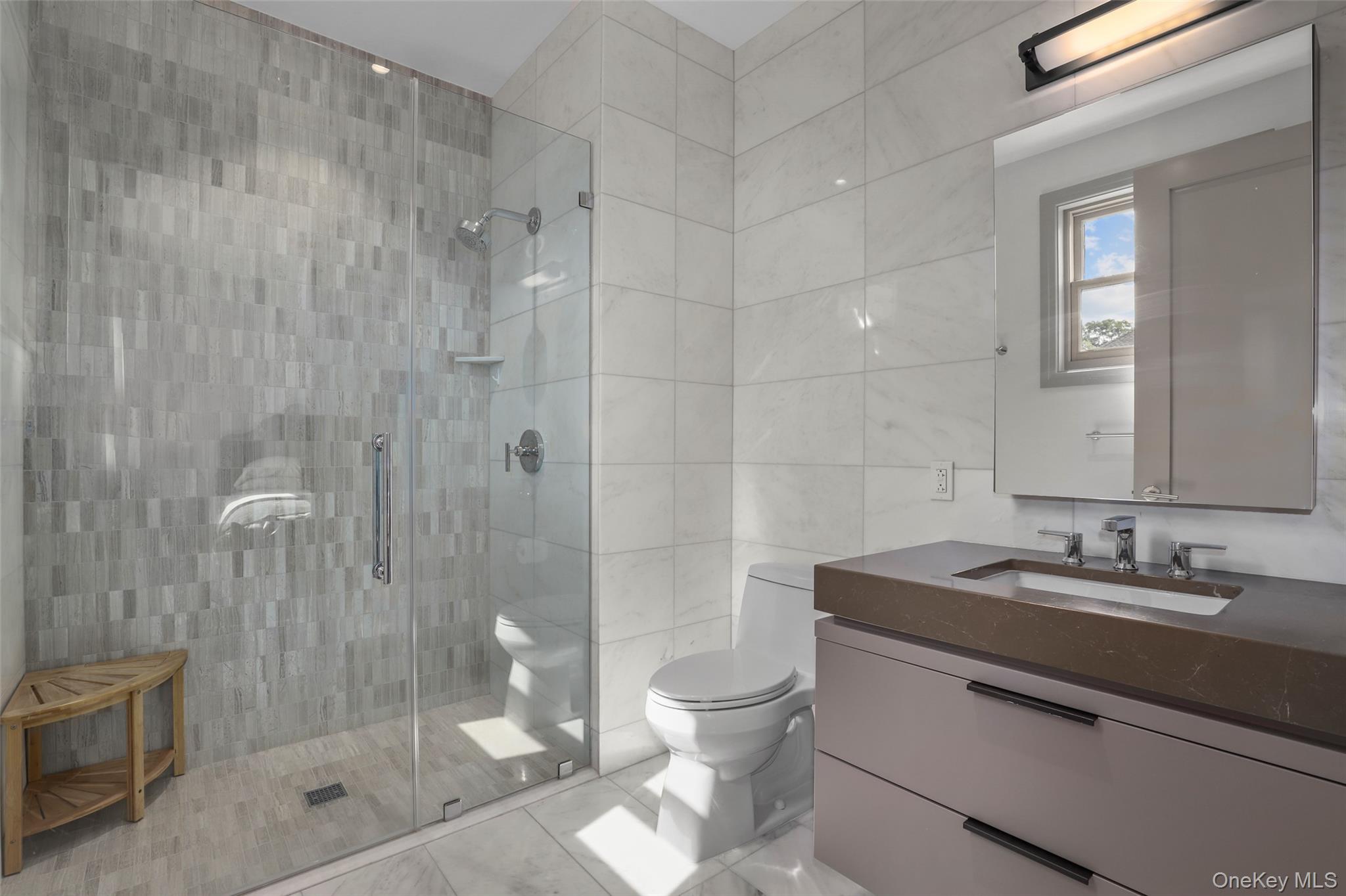 120 Old Post Road, Unit PHB301 Rye, NY 10580 - Photo 17 of 30 a bathroom with a sink a toilet and shower