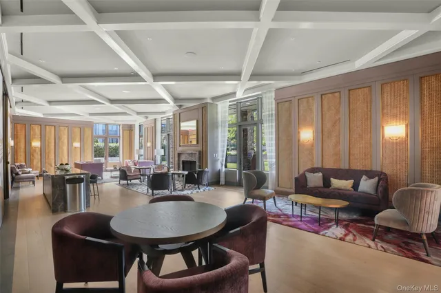 a living room with furniture a rug and a large window