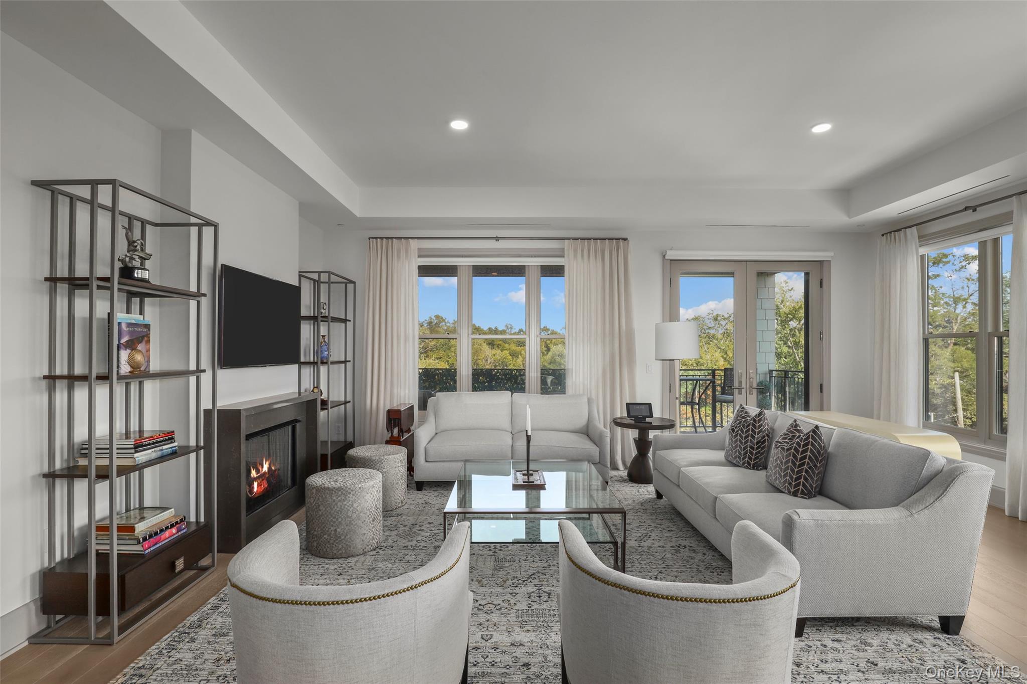 120 Old Post Road, Unit PHB301 Rye, NY 10580 - Photo 5 of 30 a living room with furniture a flat screen tv and a large window