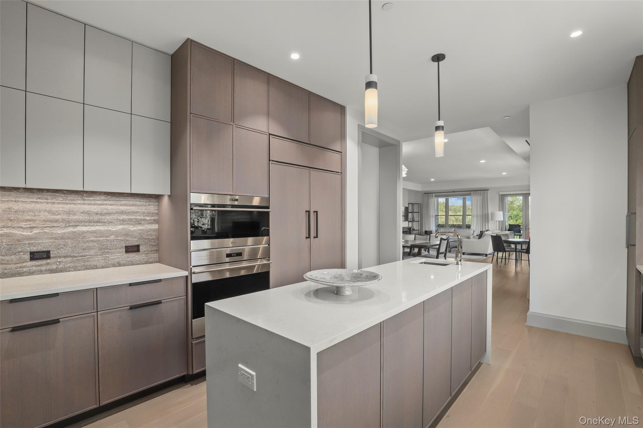120 Old Post Road, Unit PHB301 Rye, NY 10580 - Photo 8 of 30 a kitchen with kitchen island a sink stainless steel appliances and cabinets