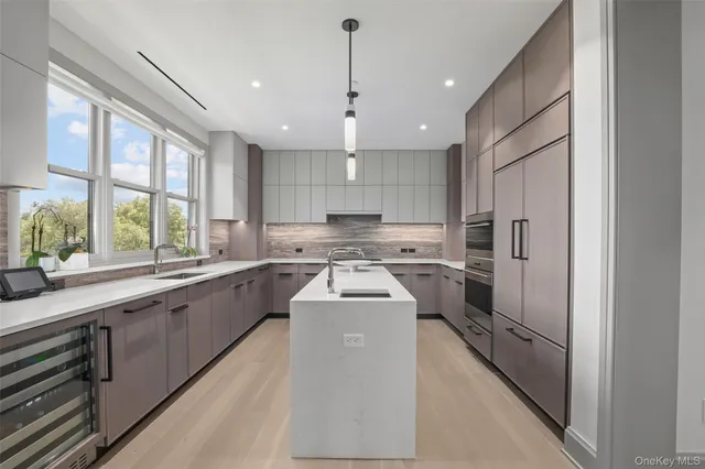 a kitchen with refrigerator a sink and a stove