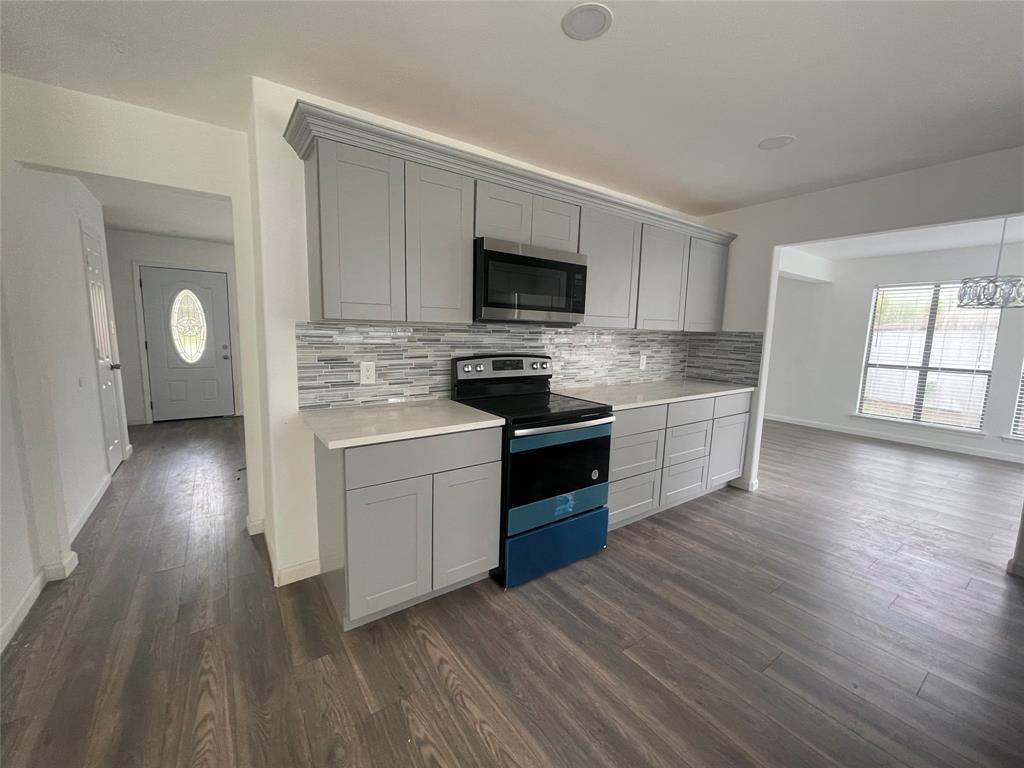 3 Ridge Drive Hickory Creek, TX 75065 - Photo 8 of 20 a kitchen with a sink wooden floor and stainless steel appliances