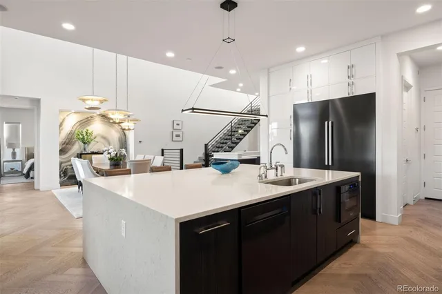 a kitchen with kitchen island sink stove and refrigerator