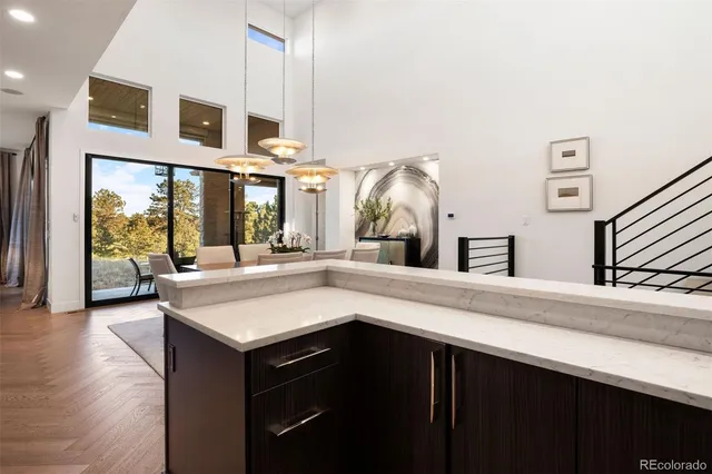 a kitchen with stainless steel appliances granite countertop a sink and a wooden floor