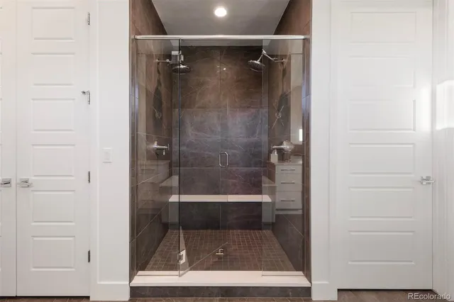a bathroom with a glass shower door