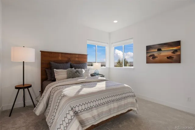 a bedroom with a bed and a lamp