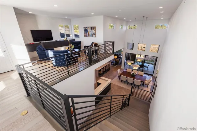 a living room with furniture a flat screen tv and kitchen view