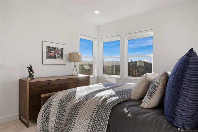 a bedroom with a large bed and a large window