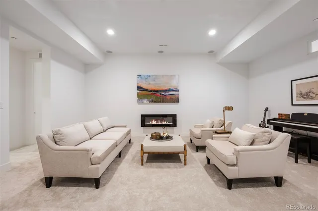 a living room with furniture and white walls