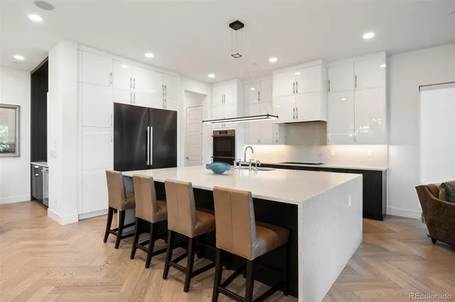 a large kitchen with kitchen island a dining table and chairs
