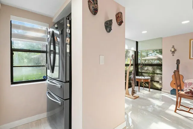 a view of a hallway with furniture and entryway