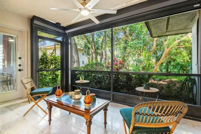 a living room with furniture and a floor to ceiling window