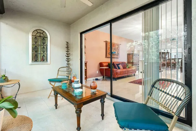 a reading room with furniture and a floor to ceiling window