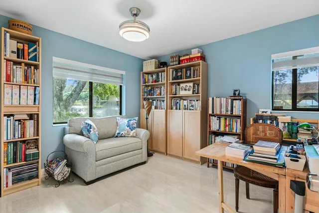 a living room with furniture and a book shelf