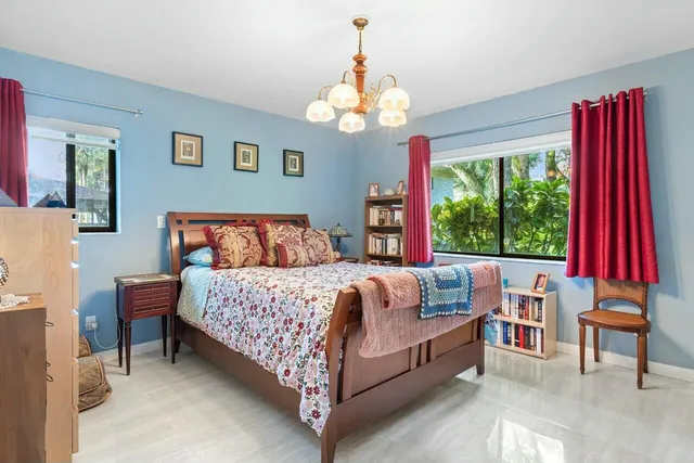 a bedroom with bed and window