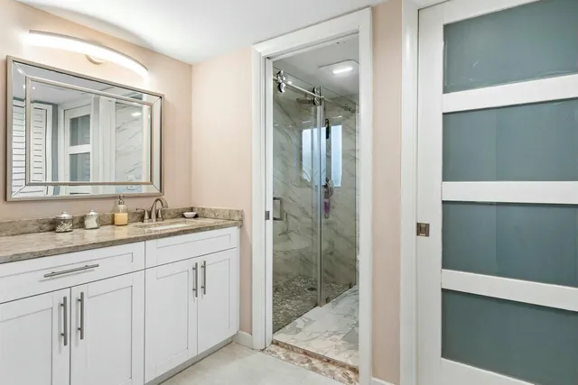 a bathroom with a granite countertop sink mirror and