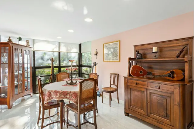 a dining room with furniture and a floor to ceiling window