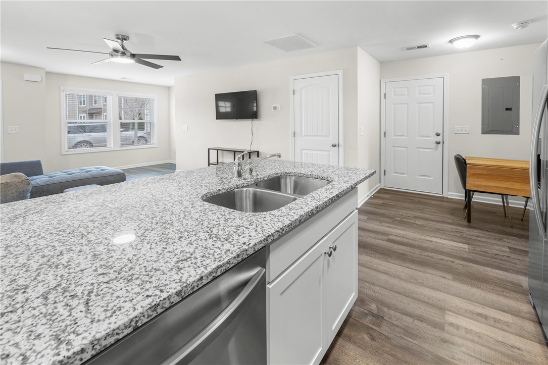 235 Pendleton Road, Unit Q1 Clemson, SC 29631 - Photo 11 of 30 This bright kitchen features a spacious island with a sink, dishwasher, and ample counter space, ideal for daily living.