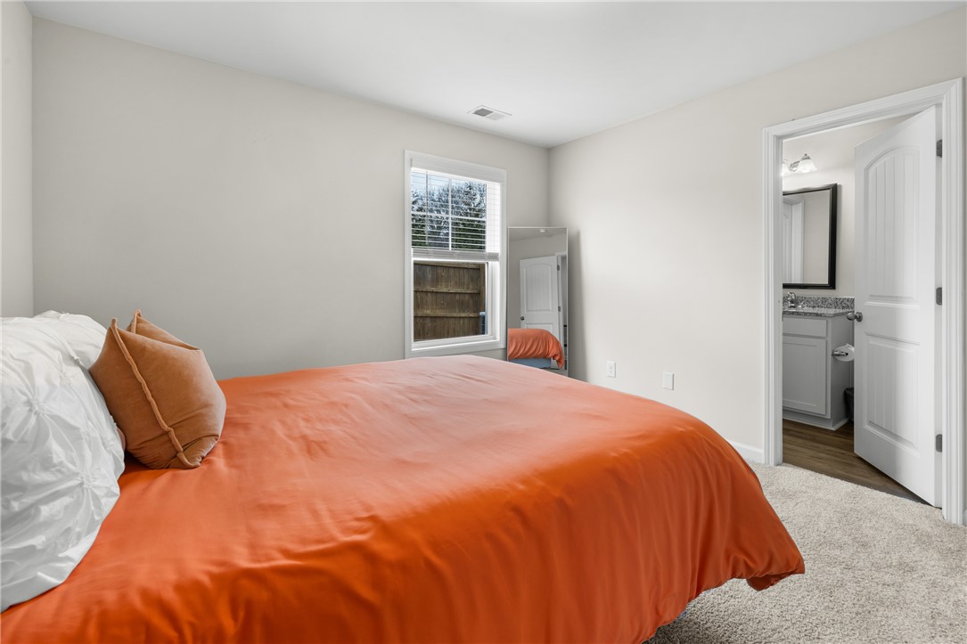 235 Pendleton Road, Unit Q1 Clemson, SC 29631 - Photo 14 of 30 This cozy bedroom features plush carpeting, a large window, and convenient access to a private bathroom.