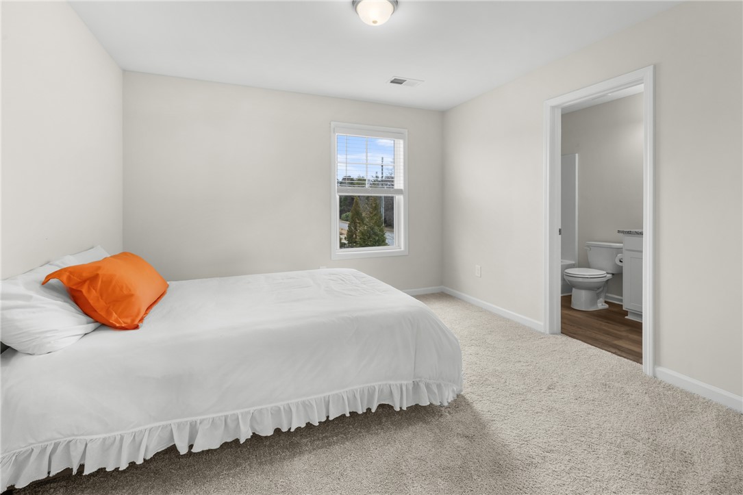 235 Pendleton Road, Unit Q1 Clemson, SC 29631 - Photo 19 of 30 This bright and airy bedroom features soft carpeting and convenient access to a private bathroom.