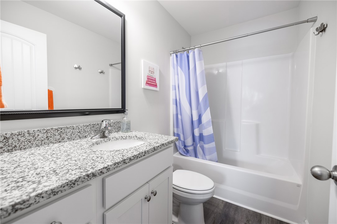 235 Pendleton Road, Unit Q1 Clemson, SC 29631 - Photo 26 of 30 This clean bathroom features a sleek vanity with granite counters and a practical shower-tub combination.