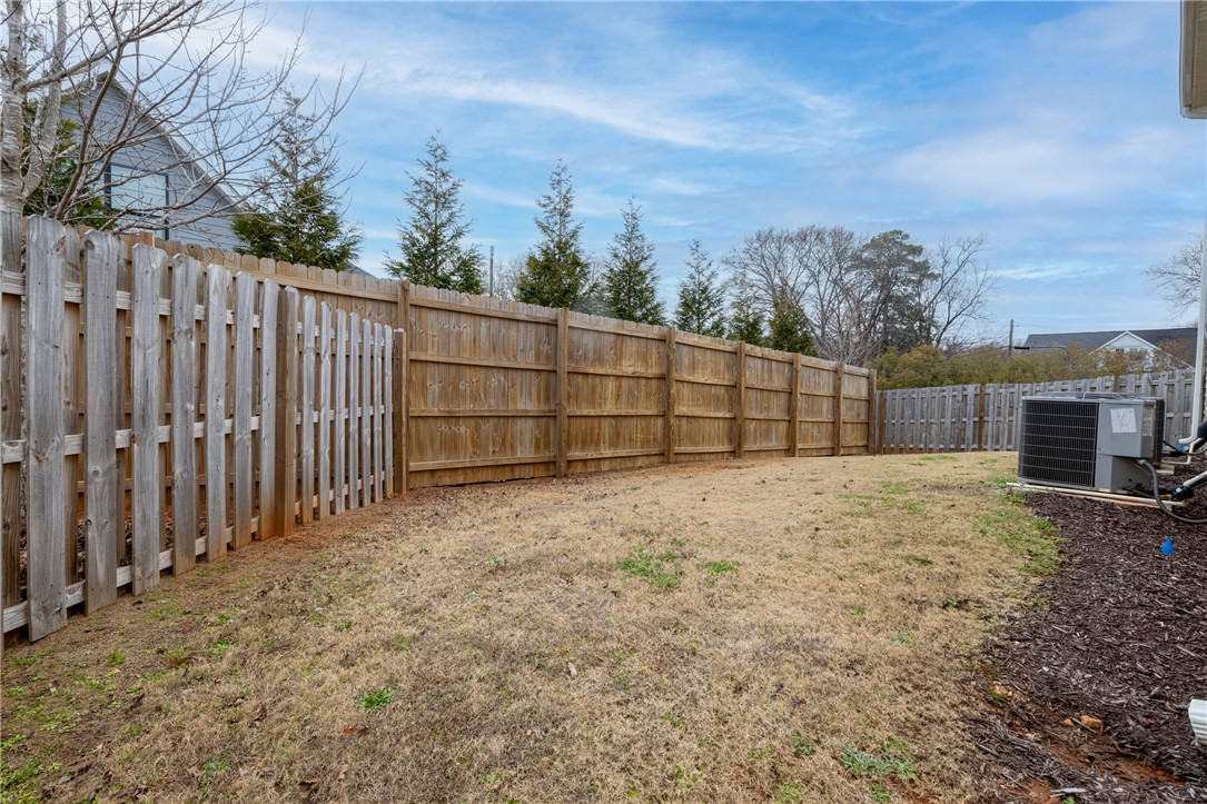 235 Pendleton Road, Unit Q1 Clemson, SC 29631 - Photo 30 of 30 This spacious yard offers privacy with its tall fencing, perfect for outdoor activities.
