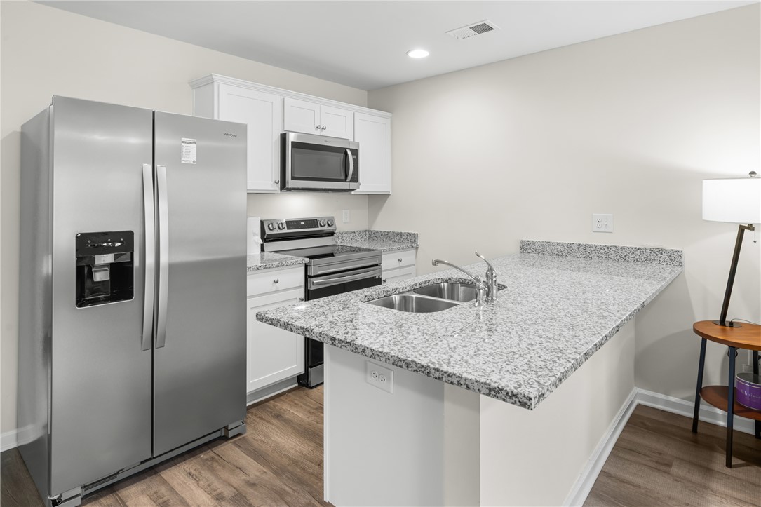 235 Pendleton Road, Unit Q1 Clemson, SC 29631 - Photo 8 of 30 This kitchen showcases beautiful countertops, ample cabinetry, and modern appliances.