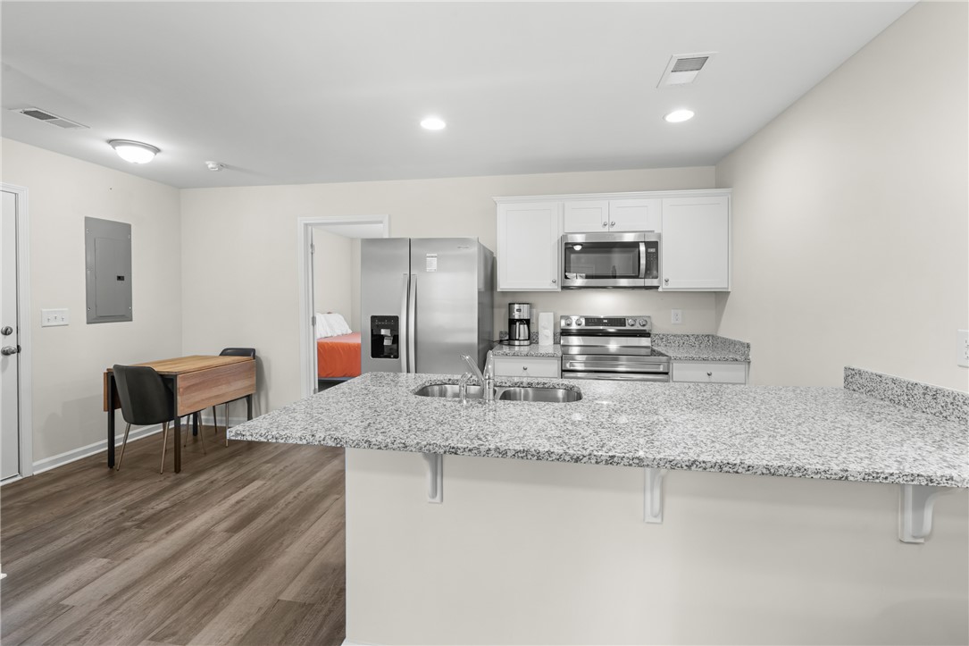 235 Pendleton Road, Unit Q1 Clemson, SC 29631 - Photo 9 of 30 This open kitchen features sleek appliances, ample counter space, and durable flooring.