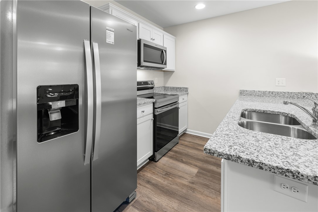 235 Pendleton Road, Unit Q1 Clemson, SC 29631 - Photo 10 of 30 This modern kitchen features sleek appliances and ample counter space, ideal for culinary endeavors.