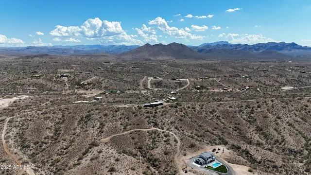 a view of a of a house with a yard and large trees