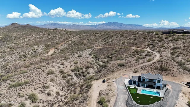 a view of a mountain in the distance in a field
