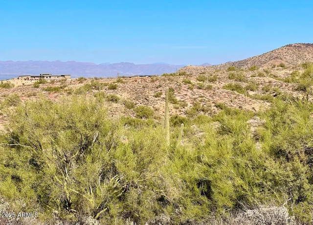a view of a large mountain with mountains in the background