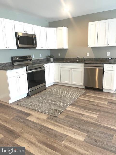 19 Pacific Avenue Milroy, PA 17063 - Photo 6 of 11 a kitchen with granite countertop a stove top oven microwave and cabinets