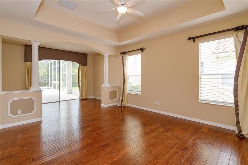 11445 Vicolo Loop Windermere, FL 34786 - Photo 14 of 28 a view of an empty room with window and wooden floor